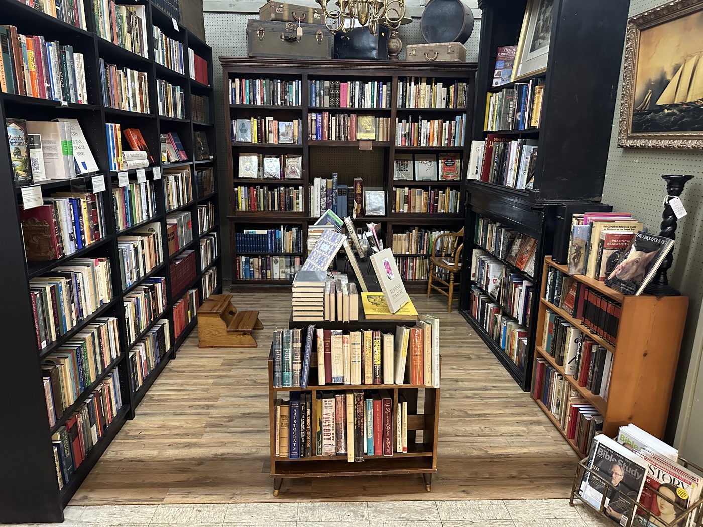 Aisle view of the booth with a center display cart of books