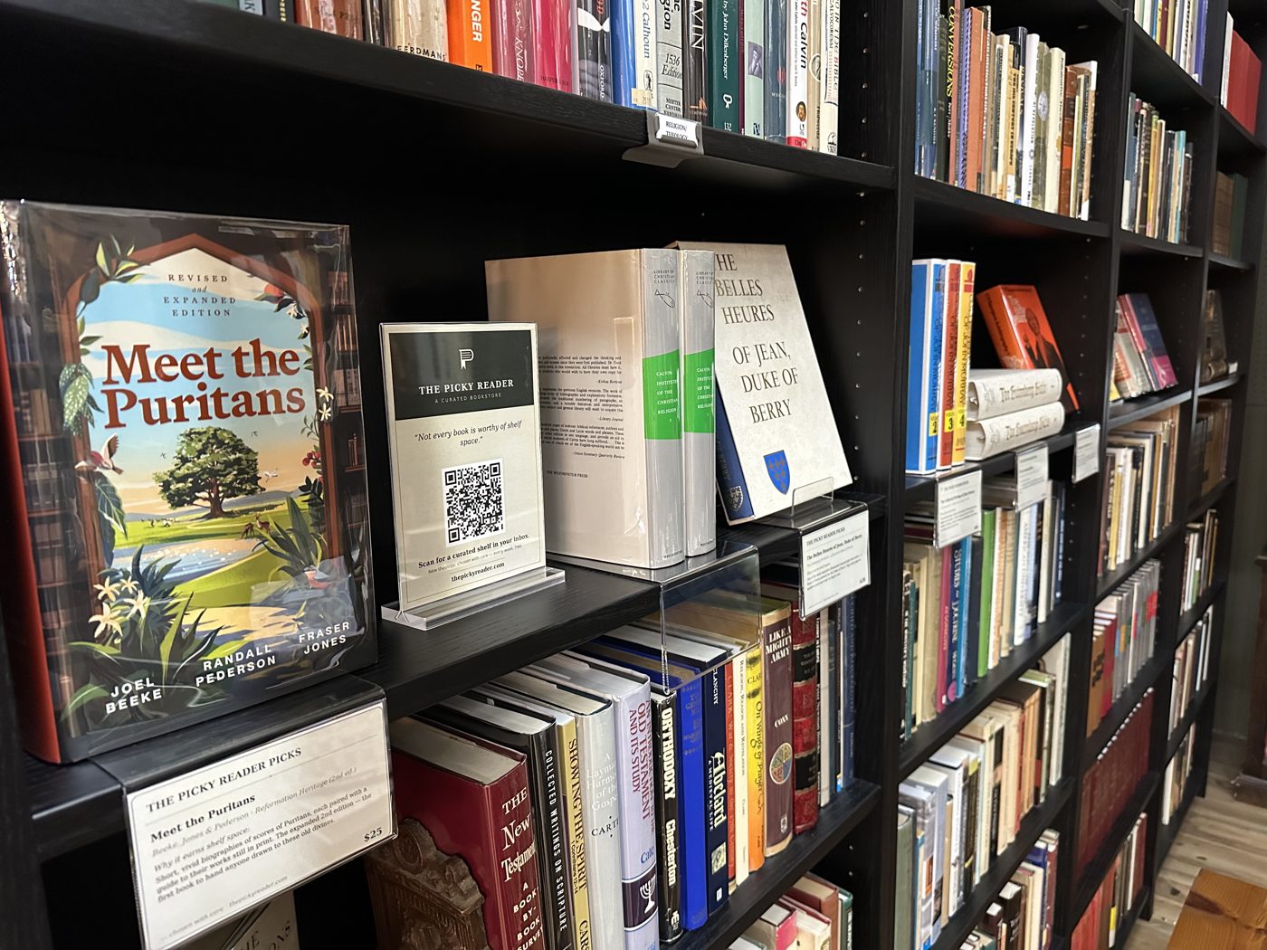 A shelf with Meet the Puritans face-out and a Picky Reader Picks card